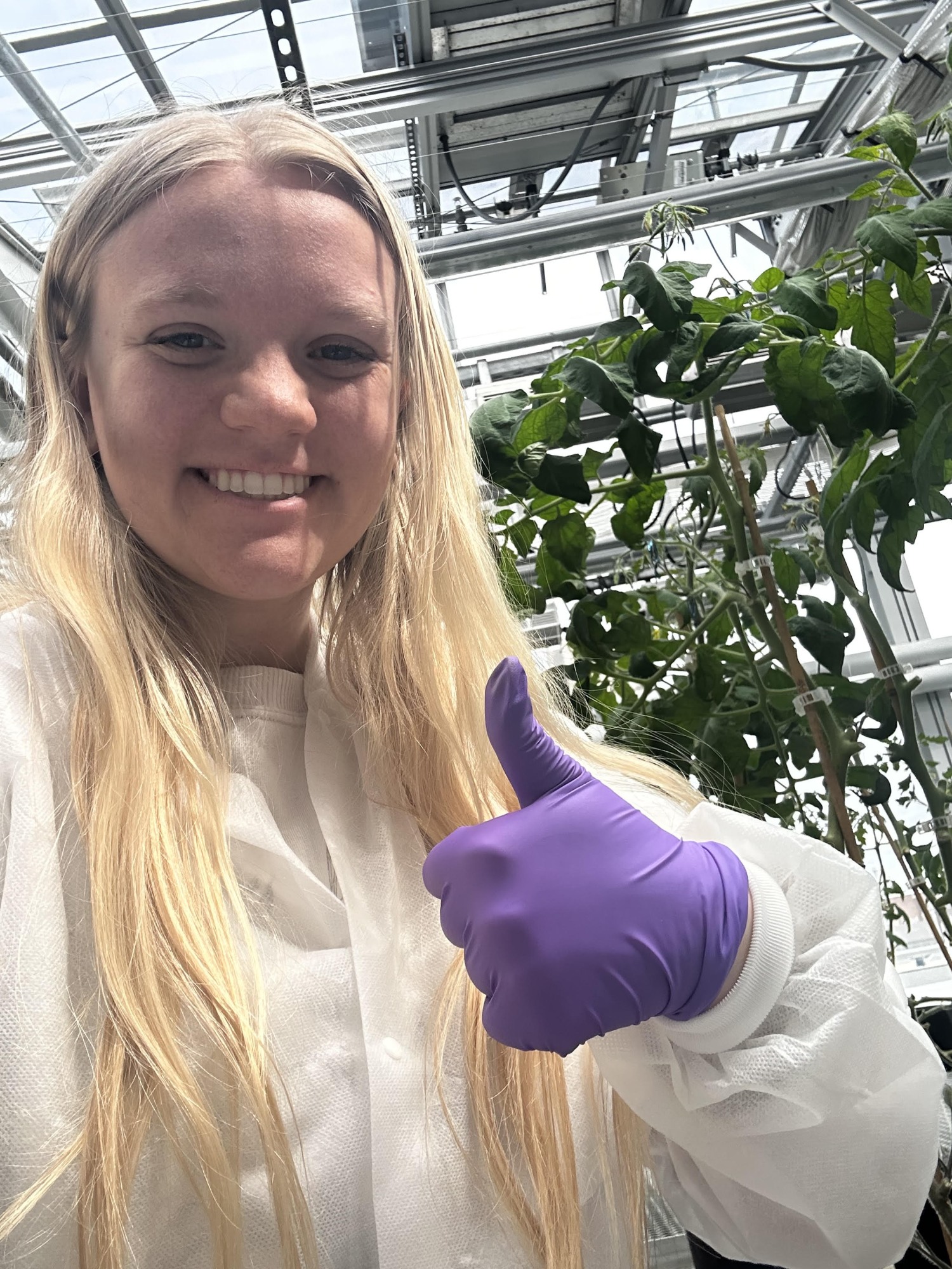 Maddie Pittigher in greenhouse